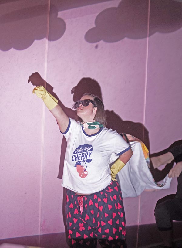 Lily Harper's character Mattie doing a superhero pose in Up Down Girl