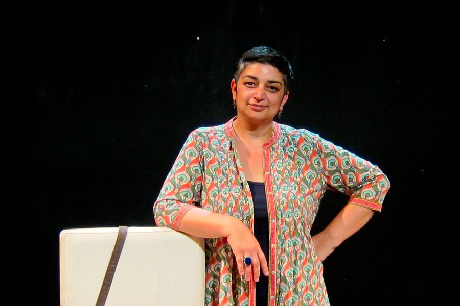 Portrait of Sameena Zehra Sameena Zehra stands with hand on her hip smiling directly at the camera