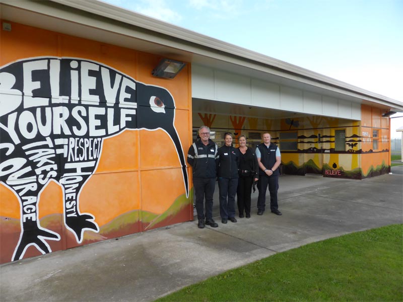 Grant Close and Alison Scarlet of Placemakers Riccarton, which donated paint towards the kiwi mural project, with Christchurch Men's Prison staff 
