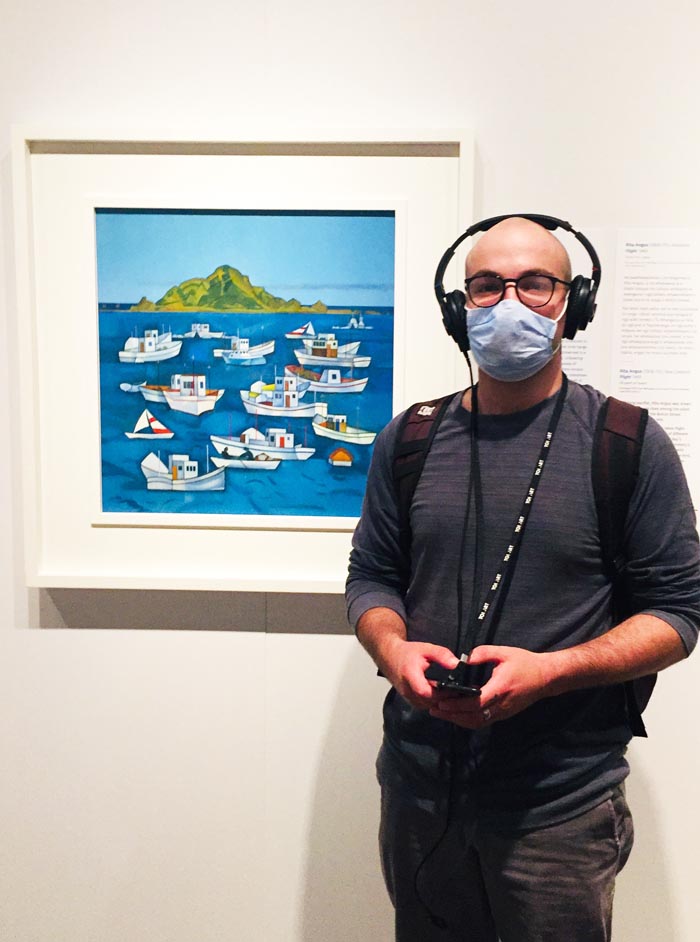 Sam Morgan in front of Rita Angus' painting, "Boats, Island Bay"