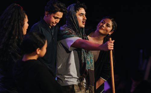 Five rangatahi performing with Ngā Rangatahi Toa