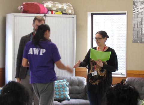 Pip Adam presents a certificate to a woman in Arohata Prison who graduated from a creative writing course