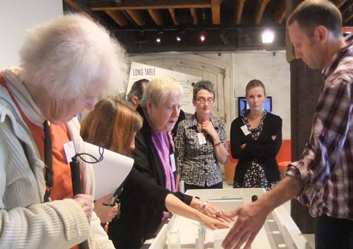 David Waller explains the tactile scale model  of The Attic to Network members