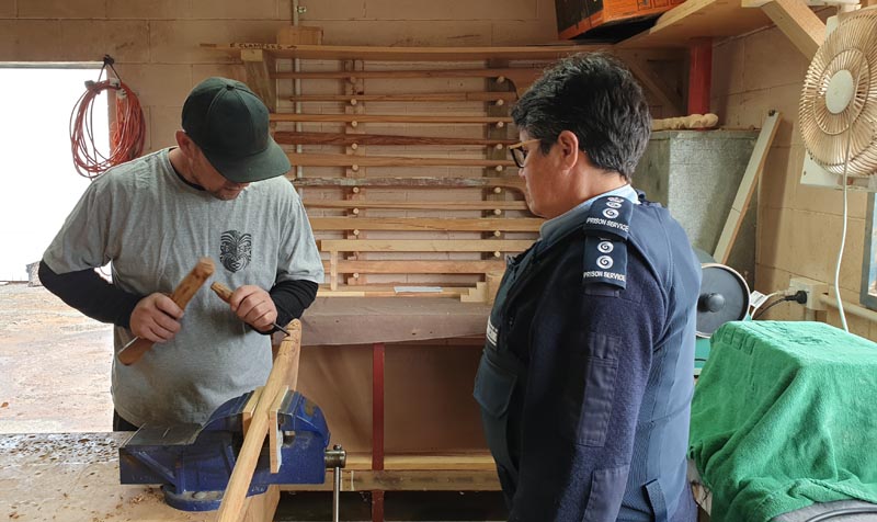 Leonie Aben engaging with one of the carvers at work  