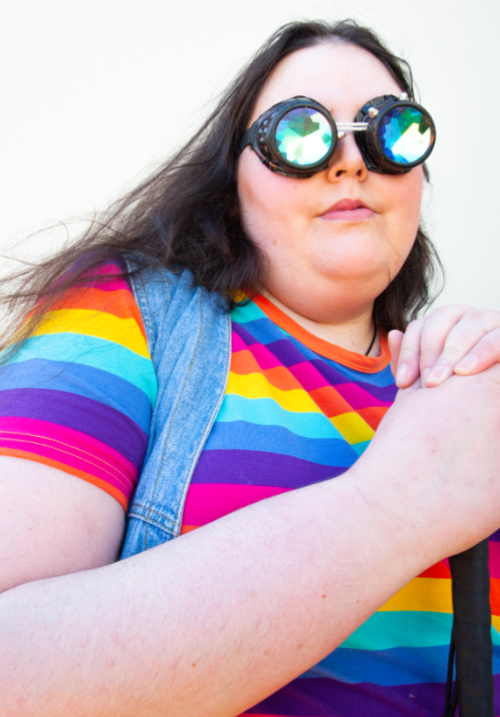 Susan Williams, in a rainbow top and steampunk goggles