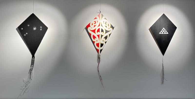 Three manu tukutuku - kites - hanging in the exhibition