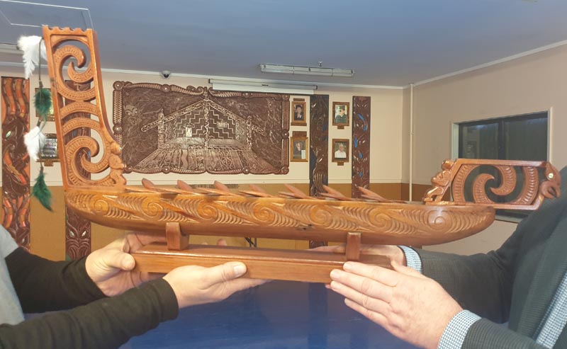 One of the award trophies, the carving of a waka by a man in Hawkes Bay Regional Prison