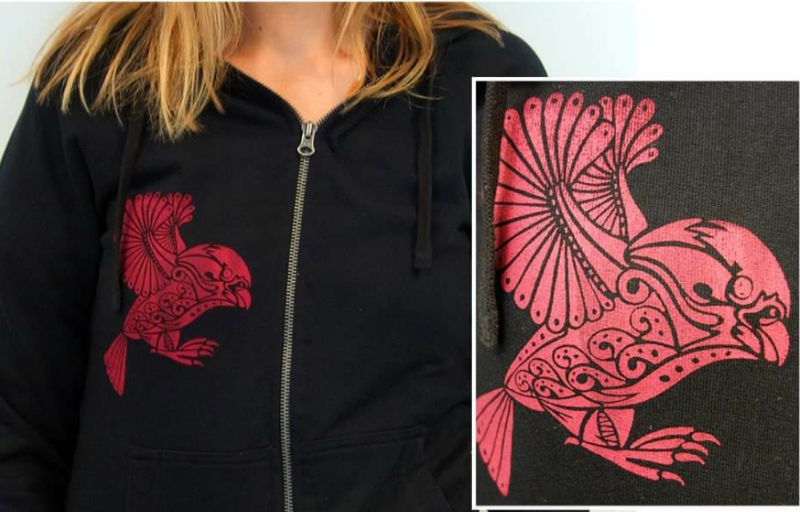 A red kea screenprinted on a black hoodie by the Navigate Initiative