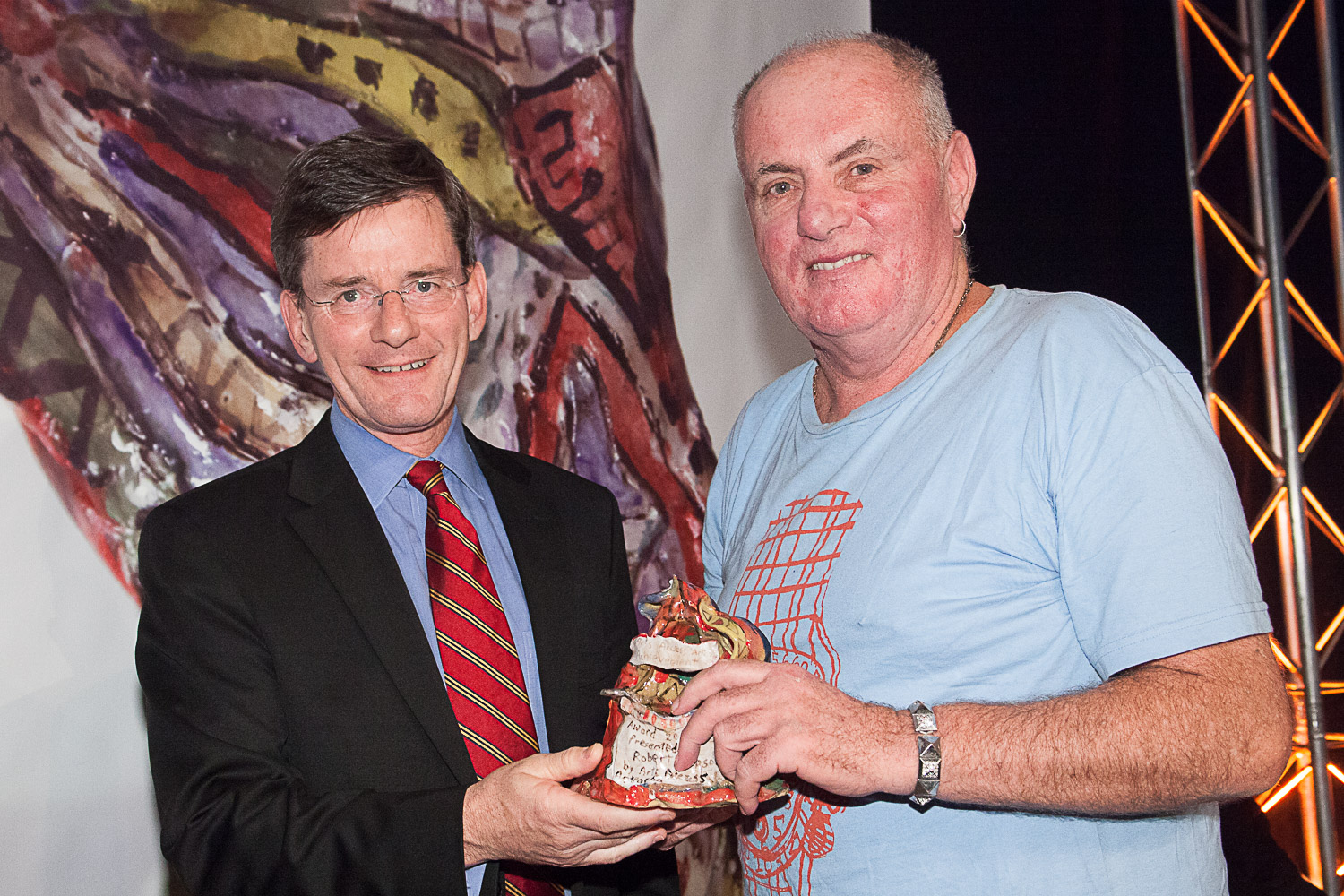 Robert Rapson, presented one of his award trophies by former Minister Chris Finlayson