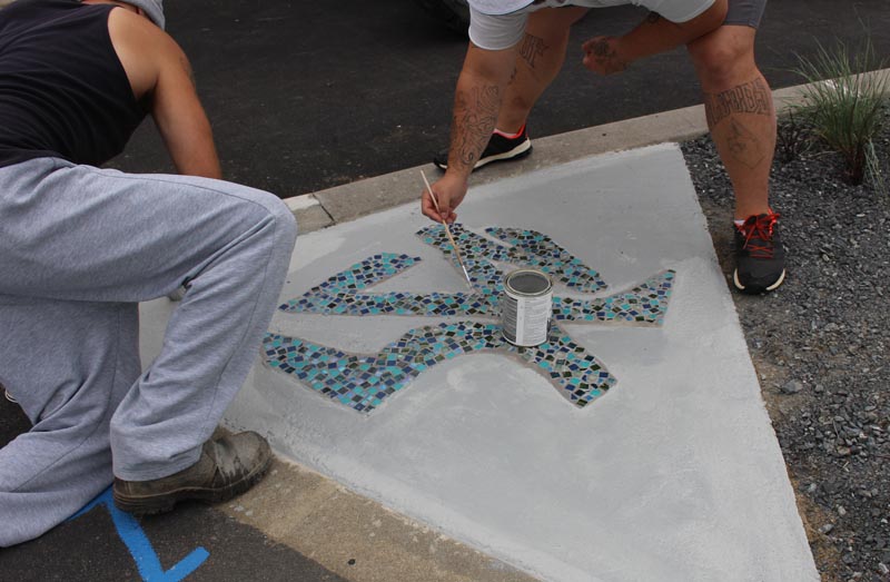 Prisoners create mosaics in the sundial garden in Puna Tatari