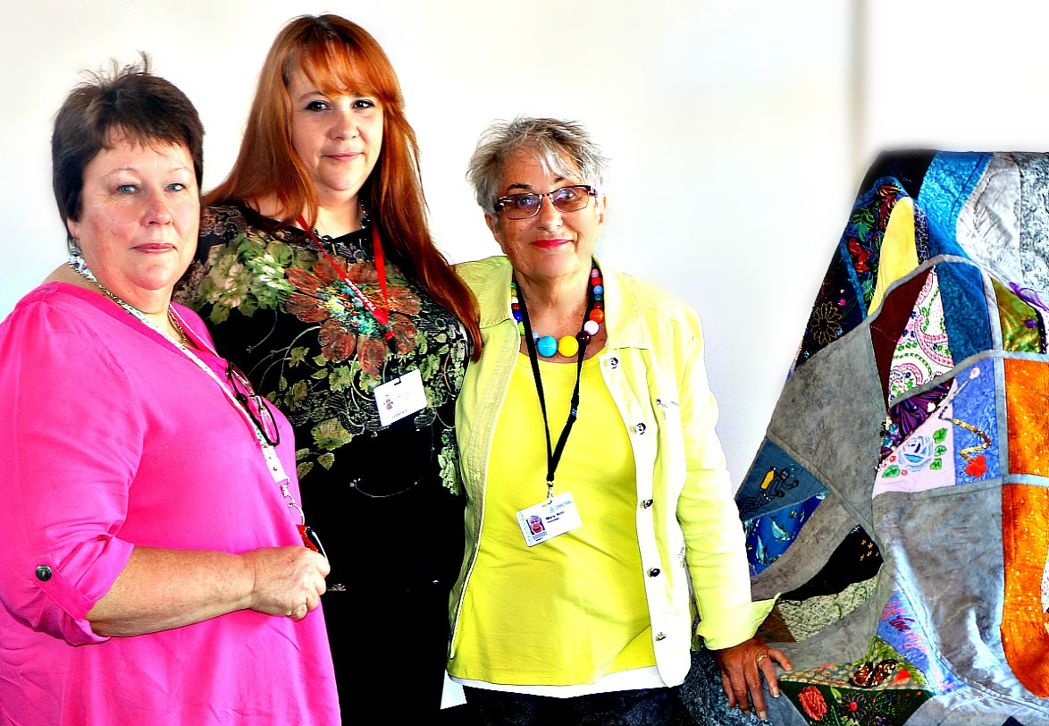 Gaye Theague, president of the Auckland Quilt Guild, and volunteers Kim Callard and Mary Ann France with Between Quilt