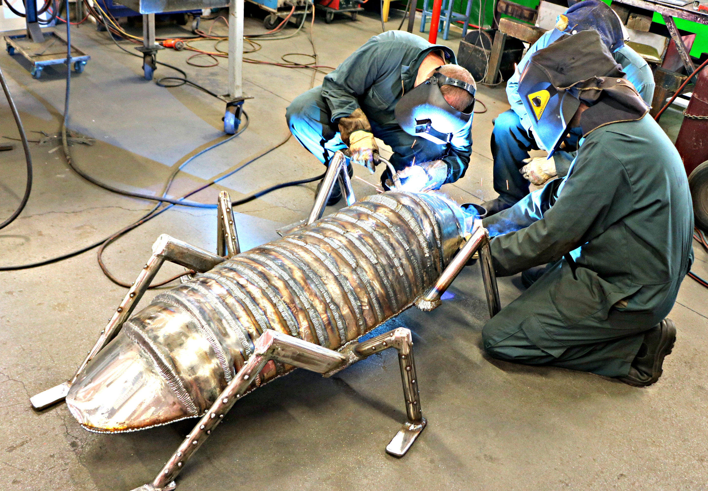 Men in the welding workshop at Auckland Prison learn to weld, making art like this giant metal insect sculpture