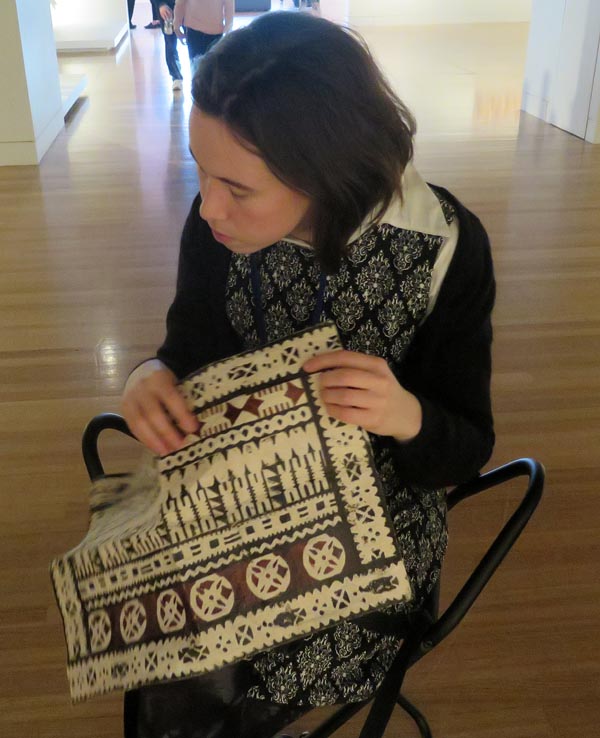 Áine Kelly-Costello touches a sample of the Fijian barkcloth called masi