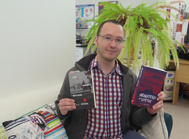 L.J. Ritchie holding his two books