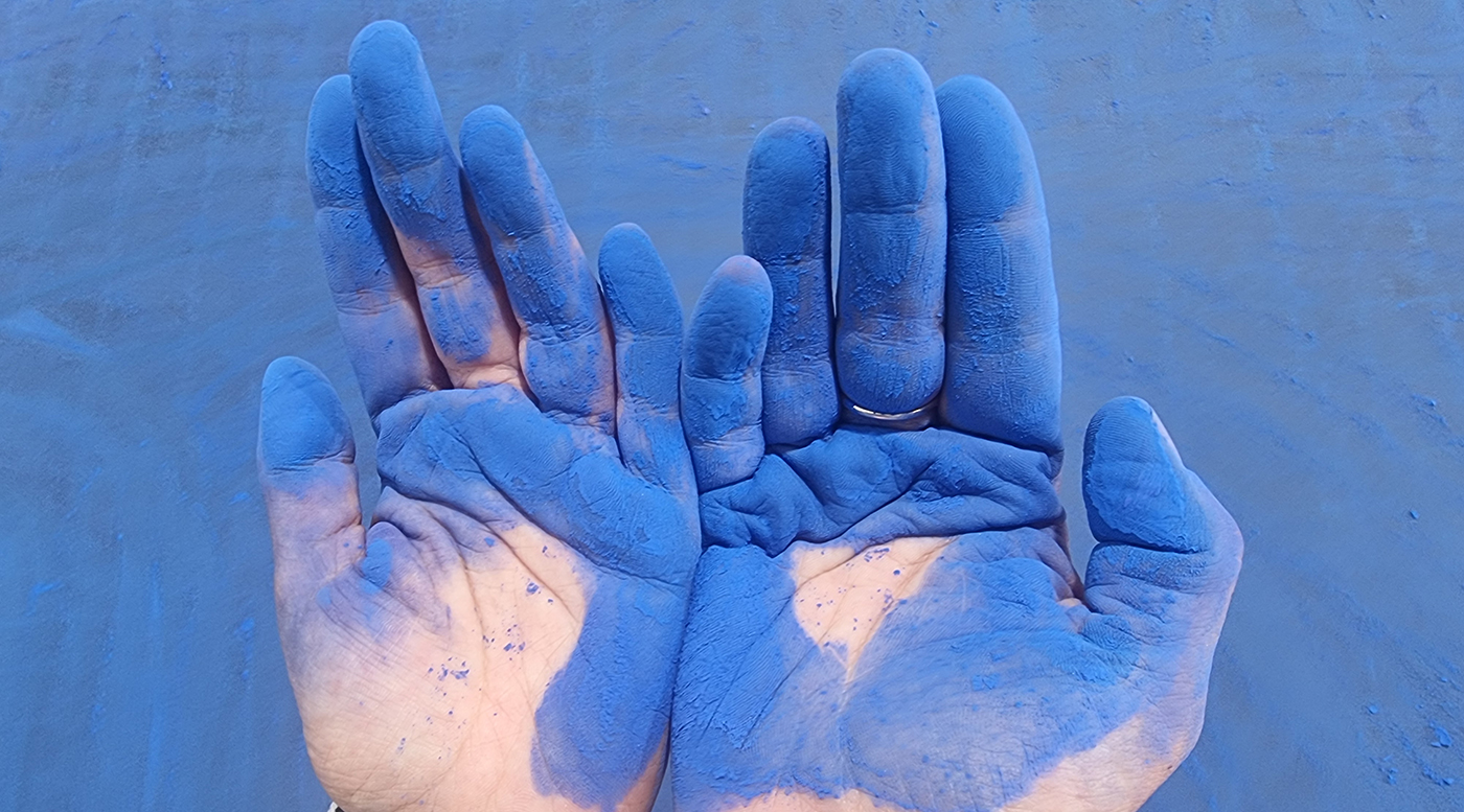 Hands with blue chalk on them