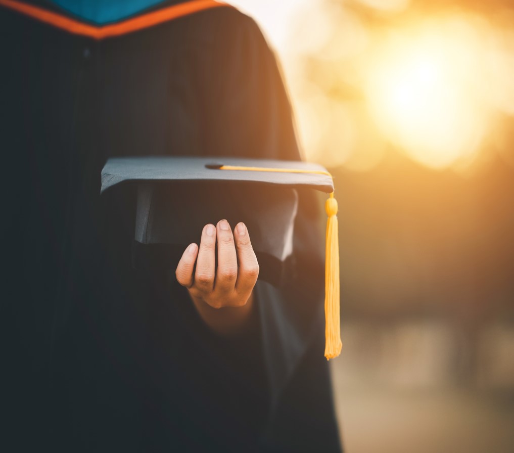 graduate holding cap